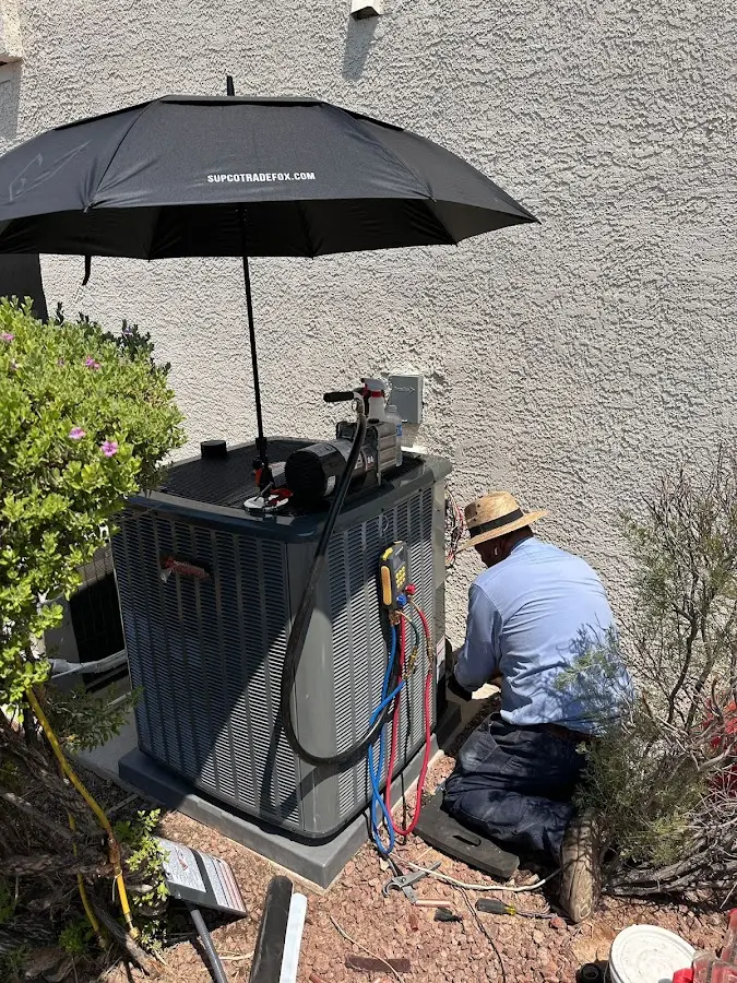 HVAC technician performing outdoor AC maintenance in Iron Mountain